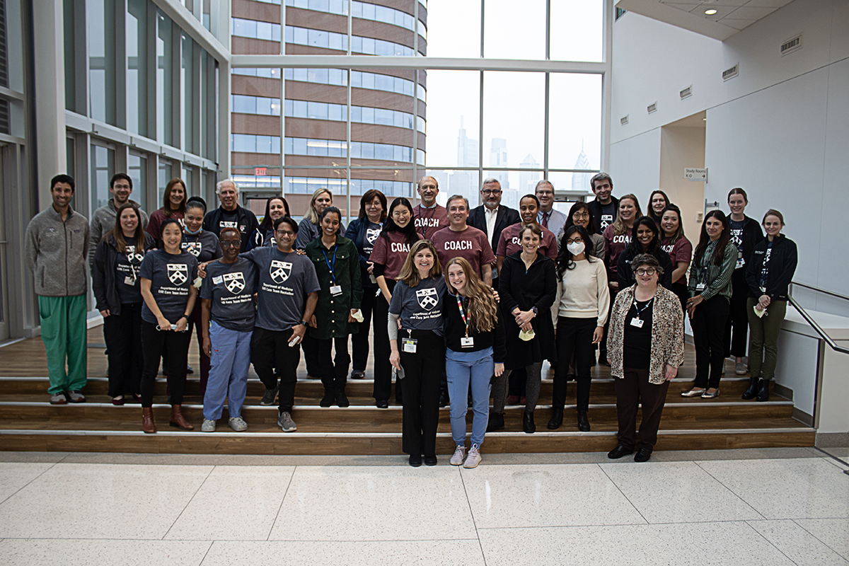 Hackathon participants standing together on a staircase