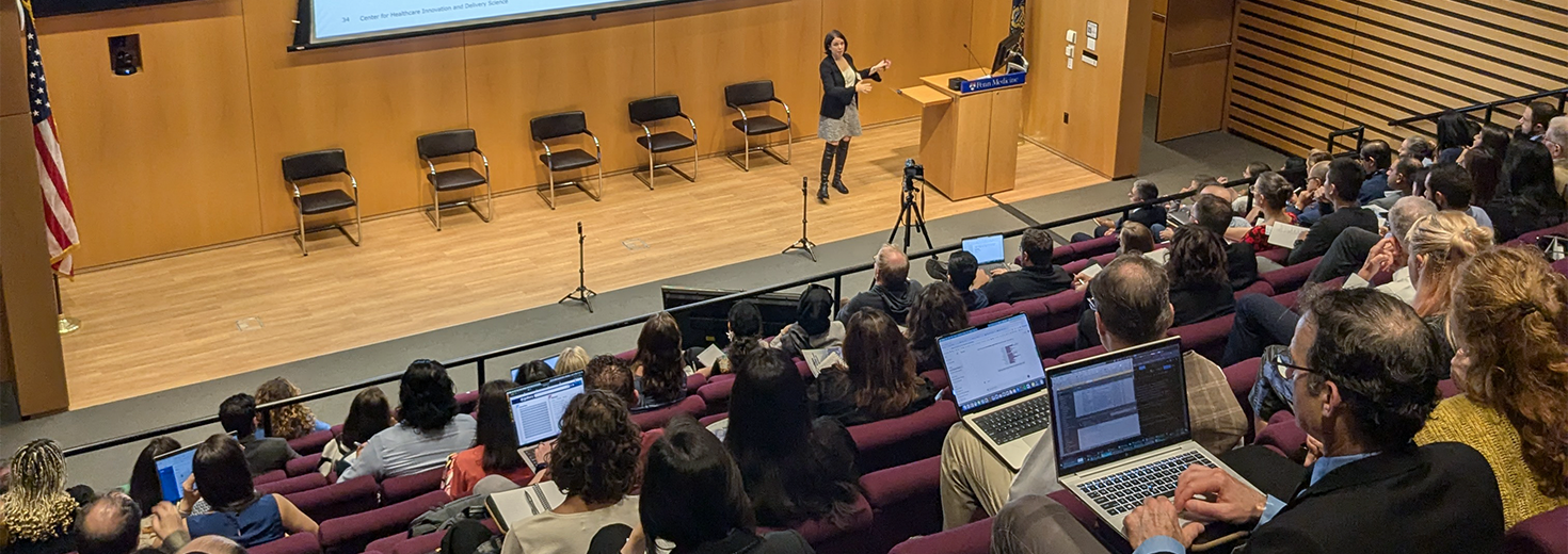 Leora Horwitz speaks to an audience in an auditorium