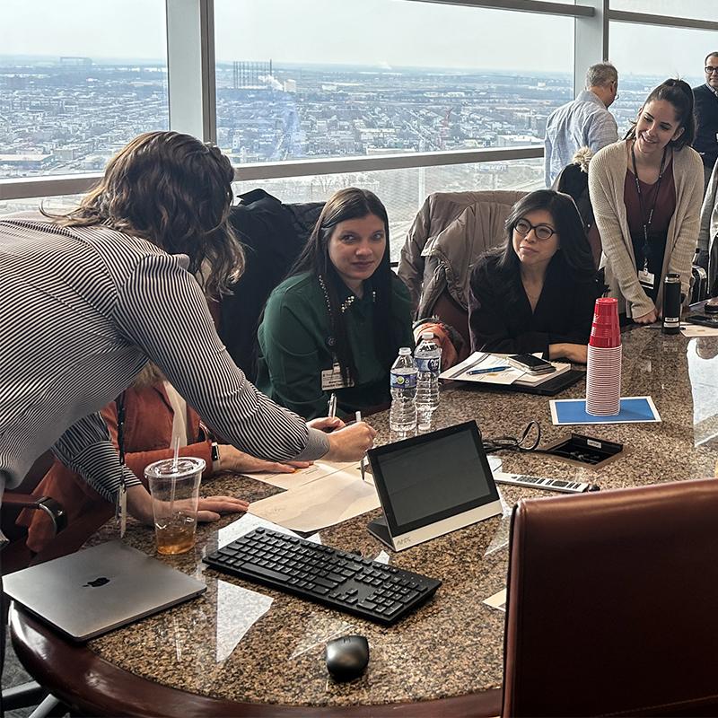 Team members at a table during the IAP 2024 kickoff