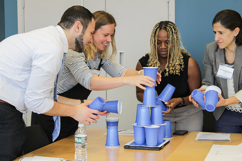 Participants in the rapid validation workshop stacking Solo cups