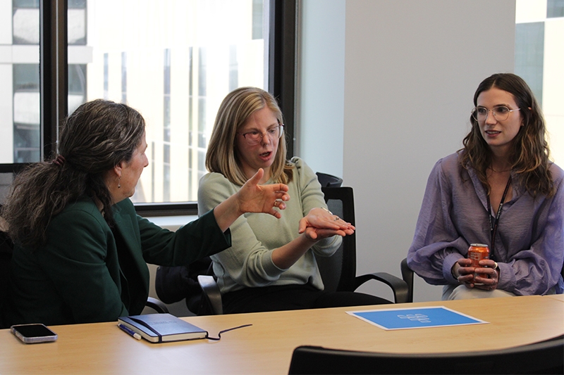 A project team discusses strategy during a kickoff event activity